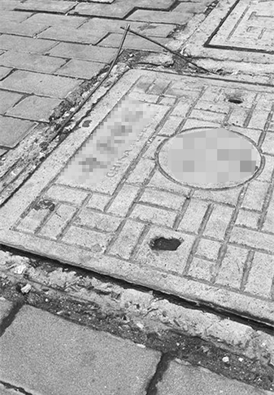 富瑞众投 井盖钢筋绊倒路人，门牙磕坏谁担责？